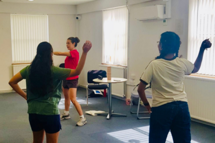 Issy leading a dance session with Afghan young people