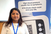 Asian lady in front of blue banner