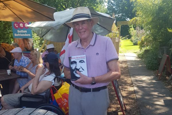 Befriender Gordon holding his most recent book