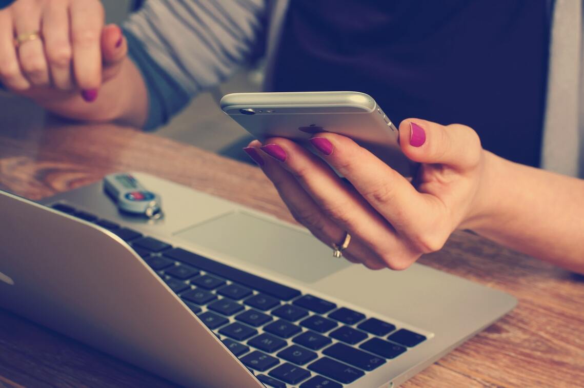 Woman with laptop smartphone and usb stick