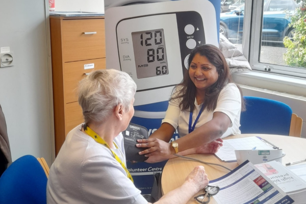Asian lady carrying out blood pressure checks