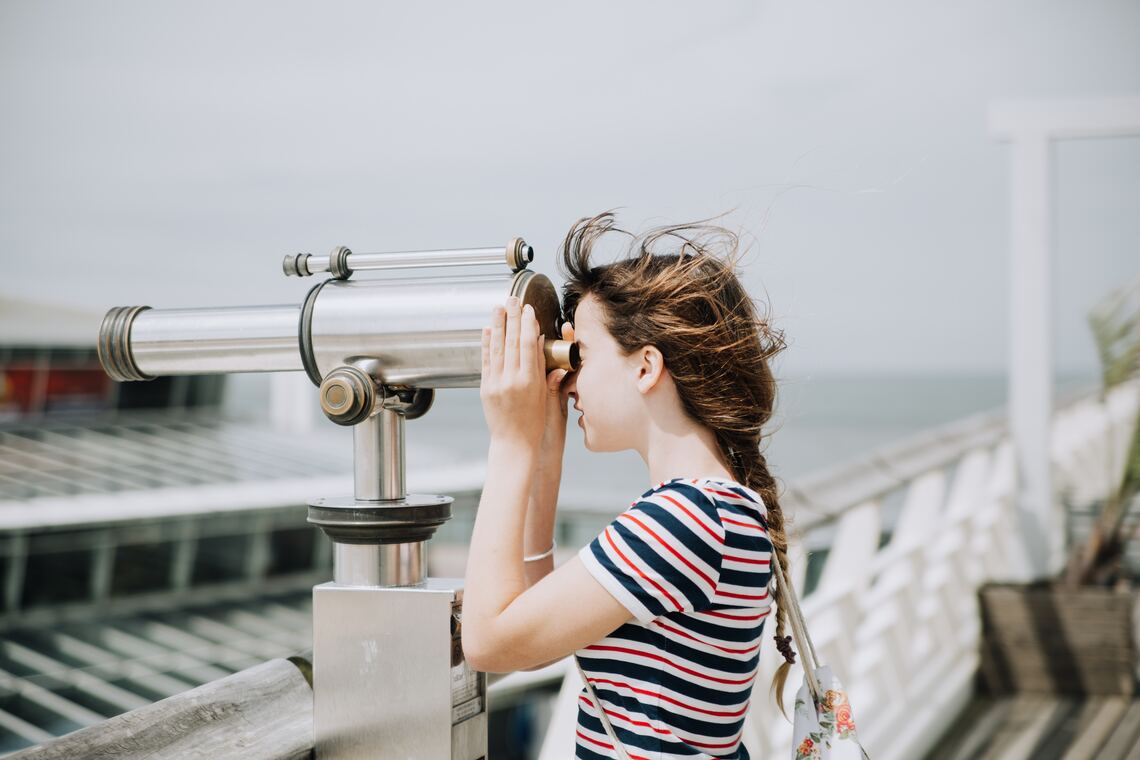 Woman looking through a telescope