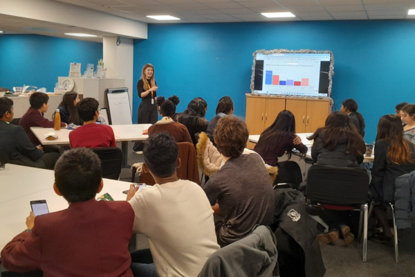 Hannah delivering a presentation to the Young Commissioners about MAPS